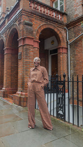Model wearing Ines vintage inspired trouser set and laughing