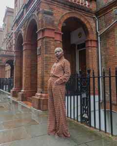 Model wearing Ines vintage inspired trouser set, looking at camera with hands in pocket
